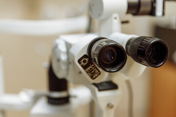 Fototapeta na wymiar View of the ophthalmic microscope on the table in the ophthalmologist's office. Modern diagnostics and treatment of vision. Diagnostic microscopic medical equipment.
