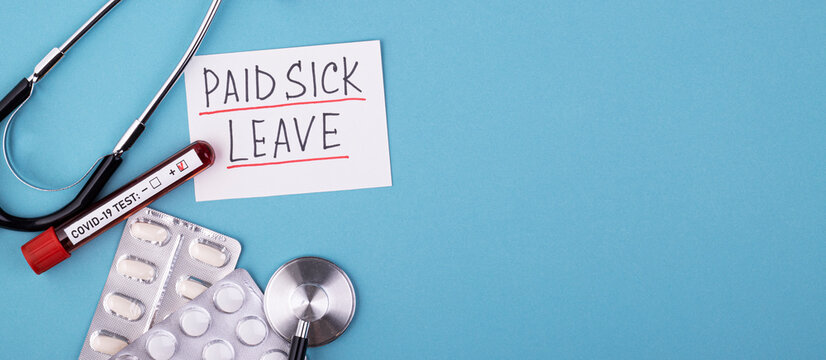 Pills, Covid Test And A Medical Phonendoscope With The Inscription Paid Sick Leave On A Blue Background