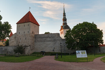 City wall and watchtower in old Tallinn, Estonia. Summer evening time.