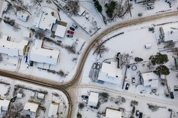 Obraz na płótnie Canvas Drone angle view of snowy suburban streets and houses in Finland
