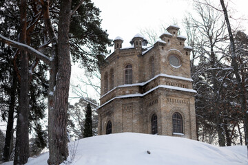 Koch family chapel ruins and family cemetery in Pirita, Tallinn during winter. Romantic neo-Romanesque building with hexagonal floor plan. Rare historical sacral architecture. Built 1984.