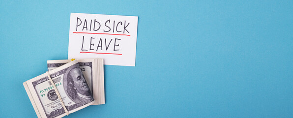 A wad of money and the inscription paid sick leave on a blue background, space for text