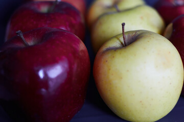 Bright red apples and a yellow apples