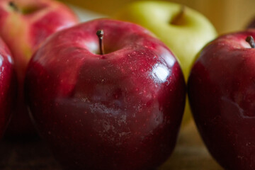 red apples and a yellow one