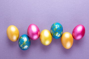 Bright colored eggs on a gray background. Easter theme, holiday. Happy easter card with copy space for text in minimalist easter style. Color of the year. Grey.