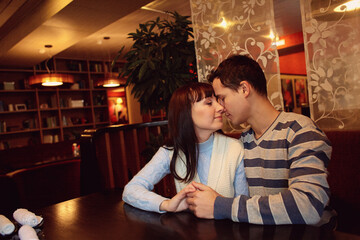 man and woman sitting in a cafe on a date. young couple in love - 406210269