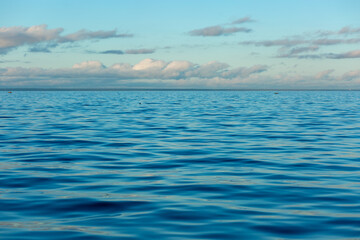 Obraz premium Turquoise water color against the sky. The Gulf of Finland. Baltic Sea. Ripples in the water. Sunny day. Background.