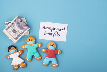 Dollars in a pack and a gingerbread family in masks the inscription unemployment benefits