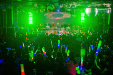 Large groups of people watch a concert in a nightclub