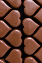 Hearts made from chocolate close-up. Vertical background for Valentine's Day. Selective focus.