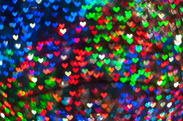 Color Bokeh on a dark background with hearts for use in graphic design