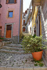 Fototapeta na wymiar A narrow street between the stone houses of Morcone, an old town in the province of Benevento, Italy. 