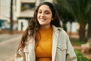 Young middle east woman smiling happy standing at the city.