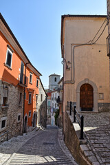 Fototapeta na wymiar A narrow street between the stone houses of Morcone, an old town in the province of Benevento, Italy. 