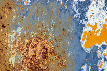 Rust, steel, background. Peeling off old paint Blue yellow white