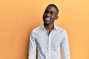 Young african american man wearing casual clothes looking to side, relax profile pose with natural face and confident smile.