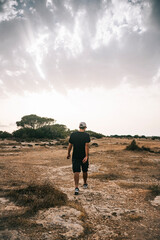 Young man walking in the countryside.