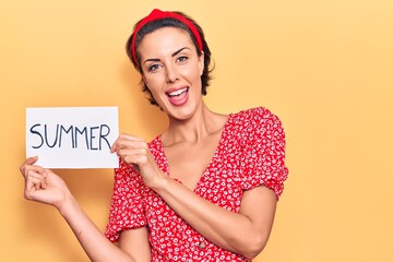 Young beautiful woman holding summer banner message looking positive and happy standing and smiling with a confident smile showing teeth