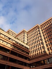 Fototapeta premium Genova, Italy - January 14, 2021: Modern construction in the city center of Genova, beautiful high skylines with grey and blue sky in the background in winter.