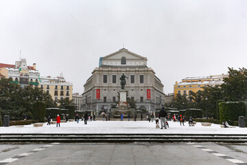 Madrid, Spain- January 9, 2021: Teatro Real de Madrid covered by snow and cold from storm Filomena. Great snowfall in Madrid. Snow storm.