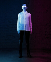 Portrait of beautiful female in pink and blue bright light. Trend cyberpunk style. Fashion model...