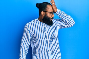 Young african american man wearing business style surprised with hand on head for mistake, remember...
