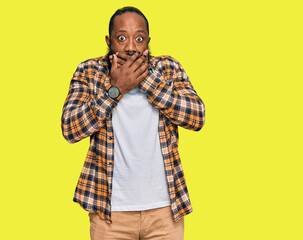 Fototapeta premium Young african american man wearing casual clothes shocked covering mouth with hands for mistake. secret concept.