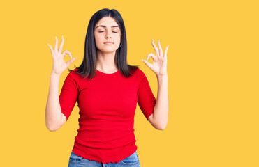 Young beautiful girl wearing casual t shirt relax and smiling with eyes closed doing meditation gesture with fingers. yoga concept.