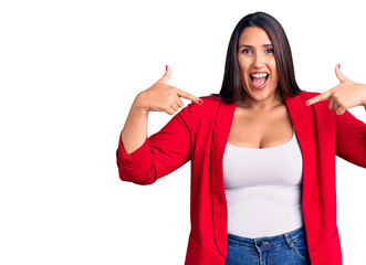 Young beautiful brunette woman wearing elegant clothes looking confident with smile on face, pointing oneself with fingers proud and happy.