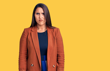 Fototapeta premium Young beautiful brunette woman wearing elegant clothes skeptic and nervous, frowning upset because of problem. negative person.