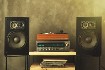 HiFi system with turntable, amplifier, headphones and lp vinyl records in a listening room - obrazy, fototapety, plakaty
