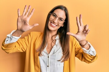 Young beautiful woman wearing business style and glasses showing and pointing up with fingers number eight while smiling confident and happy.