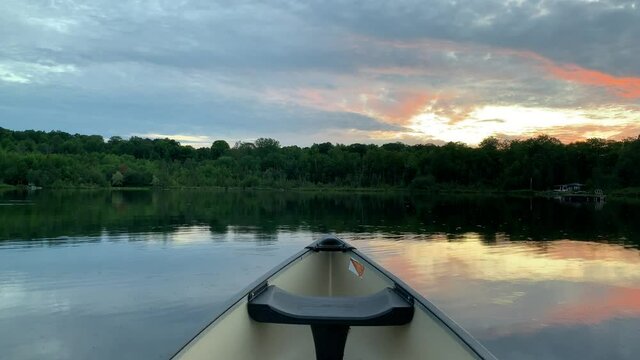 A point of view shot from the bow of a canoe on a small Ontario lake. 