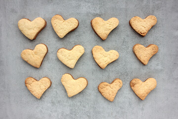 Homemade heart shaped cookies on a gray concrete background. Valentines day treats. Top view, copy space