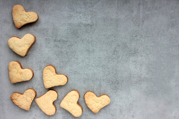 Homemade heart shaped cookies on a gray concrete background. Valentines day treats. Top view, copy space