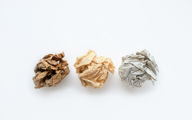 Crumpled paper balls on white background. waste recycling concept. various paper wrinkled balls, minimal composition. flat lay