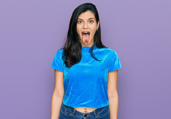 Young hispanic woman wearing casual clothes sticking tongue out happy with funny expression. emotion concept. © Krakenimages.com