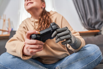 Woman playing video games with joystick at home