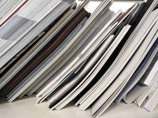 a stack of office papers and magazines. waste paper