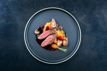 Modern style traditional wild hare back filet braised with wild berries and red wine jus with...