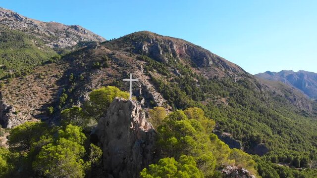 A cross on the top of a rock in Abdet village, in Alicante mountains, Spain