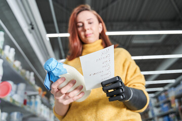 Woman checking shopping list on her smartphone at supermarket