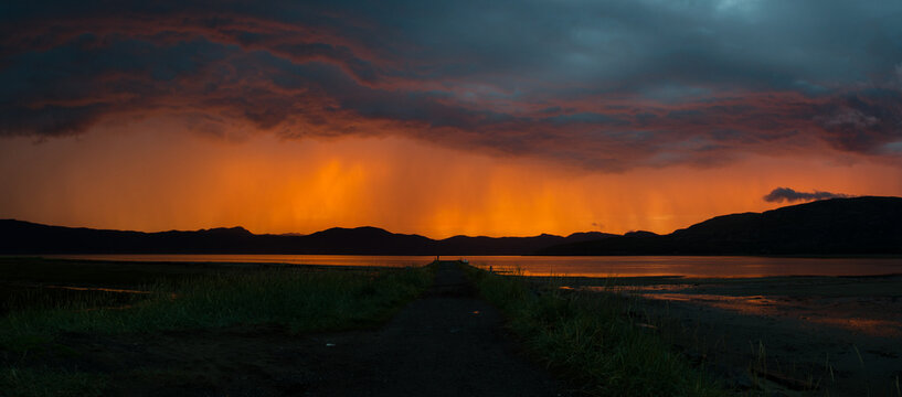 Thunderstorm panorama with midnight sun behind