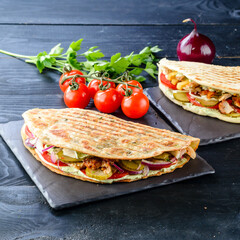 Snack. Takeaway food, street fast food. Pita bread sandwich with fresh vegetables and meat. Kebab in flat cake