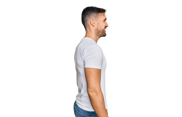 Handsome man with beard wearing casual white t shirt looking to side, relax profile pose with natural face with confident smile.