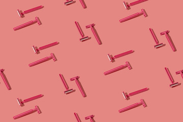 Pink safety razors pattern on a pastel pink background. Minimal monochromatic layout.