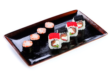 Close-up of traditional Japanese sushi on white background. Design of the sushi bar menu. Japanese cuisine. different versions of sets of sushi rolls maki on plate isolated