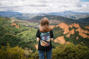 Unrecognizable alternative woman looking at the mountains