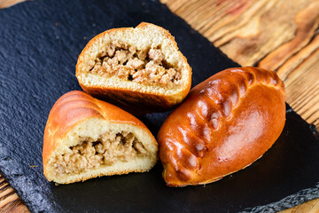russian homemade hearty pies with different fillings. Homemade baking. Traditional Russian and Ukrainian cuisine.