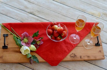 Bowl of fresh strawberries and champagne for celebration of romantic events such as Valentine's Day, marriage proposal, birthdays, Christmas, New Year's, Easter, Mother's Day, photo concepts